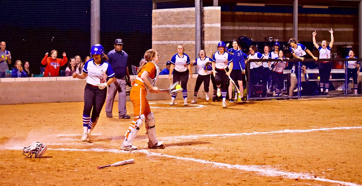 Quitman sensed hope for a comeback rally when Ashley Davis pounded a line drive off the right field fence and rounded the bases for this inside-the-park homerun. [see more fields of view]